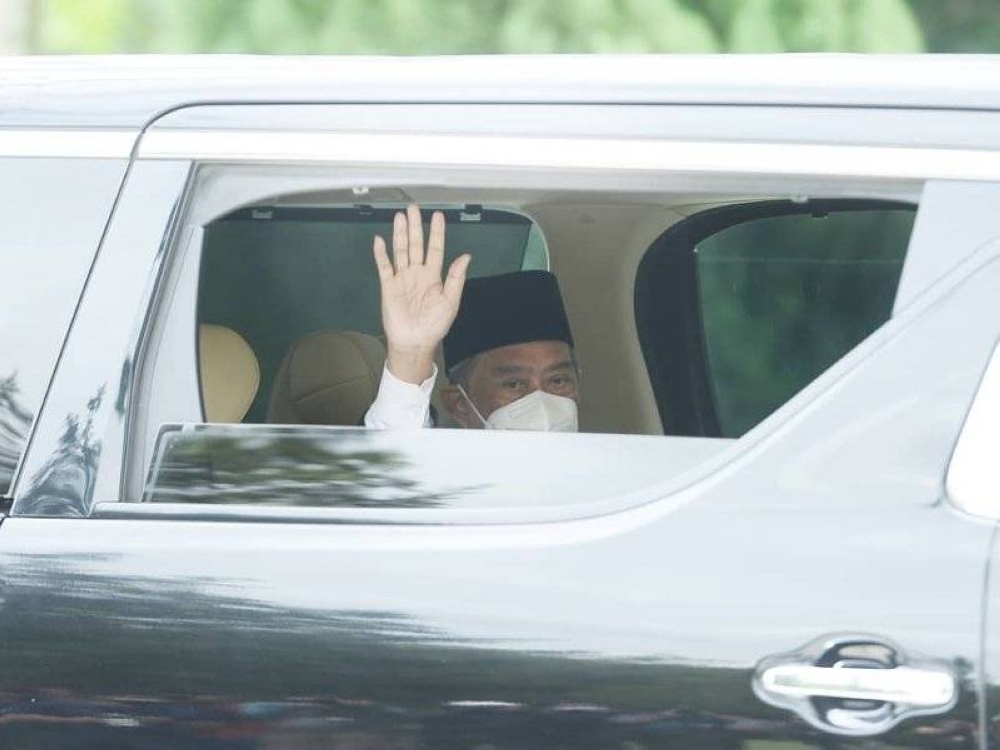 Muhyiddin melambai ke arah petugas media selepas selesai menghadap Yang di-Pertuan Agong di Istana Negara pada Isnin.