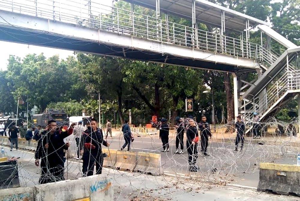 Pihak berkuasa berkawal bagi menghalang tunjuk perasaan kenaikan harga minyak di Jakarta . - Foto Antara