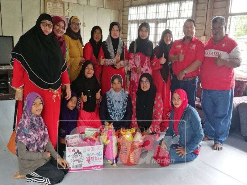 Rombongan Srikandi Bersatu ke rumah Hasmah (tengah) untuk menyerahkan barangan keperluan dapur.