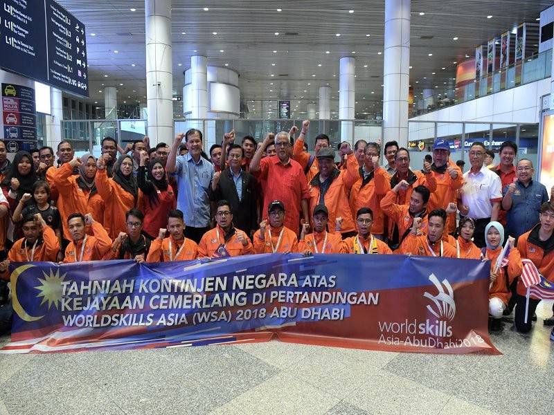 Timbalan Menteri Sumber Manusia Datuk Mahfuz Omar (berdiri lapan, kanan) dan Timbalan Menteri Kerja Raya Mohd Anuar Mohd Tahir (berdiri tujuh, kiri) bergambar kenangan bersama kontinjen Malaysia pada Majlis Sambutan Kontinjen Malaysia dari WorldSkills Asia (WSA) Abu Dhabi 2018 di Lapangan Terbang Antarabangsa Kuala Lumpur (KLIA) hari ini.
Kontinjen Malaysia berjaya memenangi tiga pingat emas, tiga pingat perak dan lima pingat ‘Medallion Of Excellent’ daripada 17 bidang kemahiran yang dipertandingkan melibatkan penyertaan 19 buah negara termasuk Malaysia.- Foto Bernama.