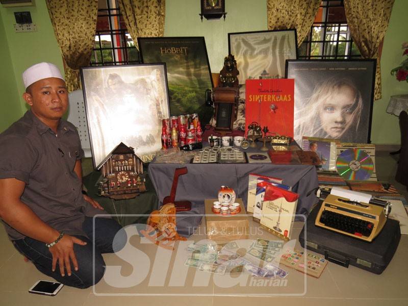 Muhamad Taoufiq bersama sebahagian koleksi barangan lama miliknya di Kampung Parit Haji Idris, Bukit Gambir, Tangkak.
