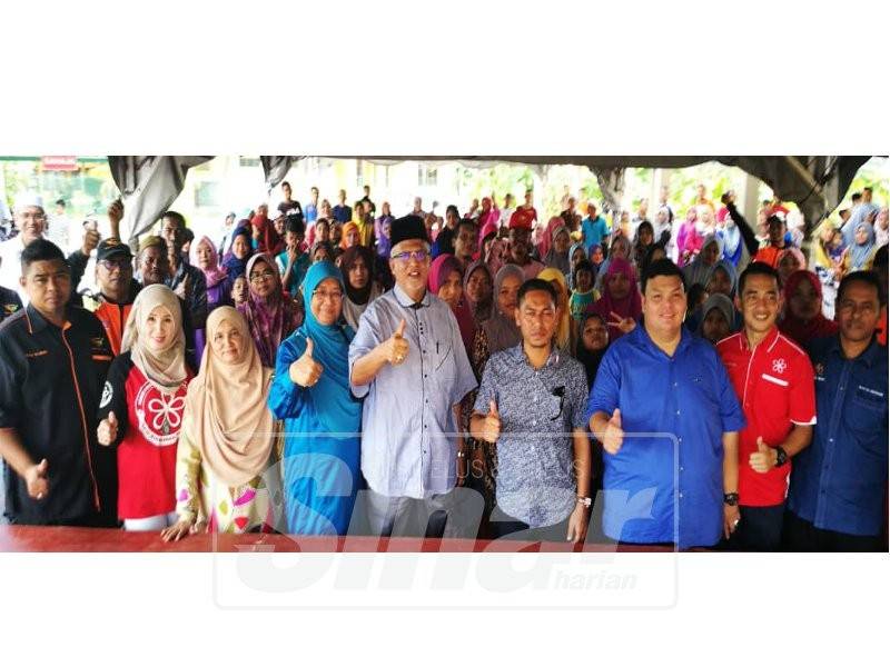 Mahfuz (tengah) bersama sebahagian penerima sumbangan.