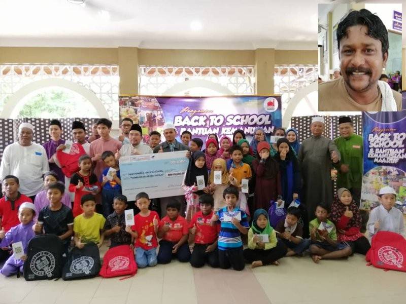 Sebahagian penerima sumbangan kembali ke sekolah Masjid Abdul Rahman Auf. Gambar kecil, M Raman.