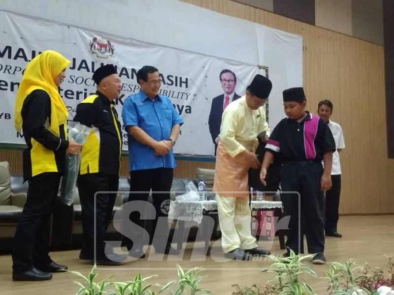 Mohd Anuar (empat, kiri) menyerahkan sumbangan kepada penerima terpilih dalam majlis tersebut.
