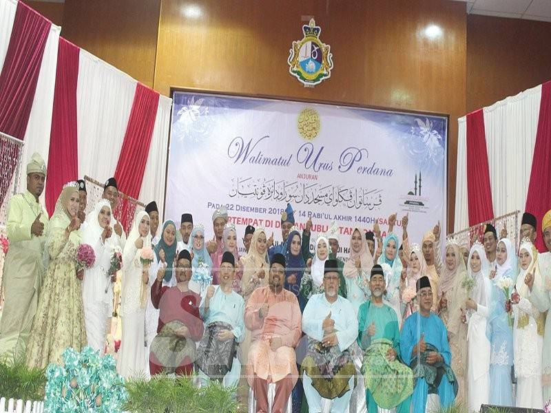 18 pasangan pengantin yang menyertai program Walimatul Urus Perdana di Dewan Jubli Intan Sultan Ibrahim bergambar kenangan bersama.
