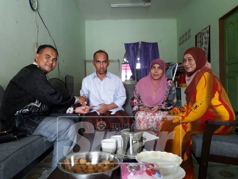 Asmara (dua dari kiri) menerima kunjungan Ahmad Shafri (kiri) dan Zarina yang hadir menyampaikan bantuan kebajikan Kawat.