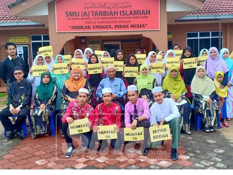 Ahamad (duduk belakang, empat kiri) bersama calon SMU dan guru yang terlibat pada majlis penyerahan keputusan peperiksaan berkenaan di sini, hari ini.
