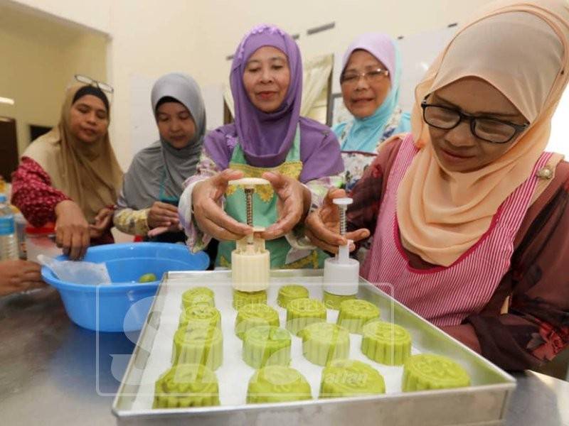 Peserta melakukan proses membuat kuih bulan pada bengkel terbabit.