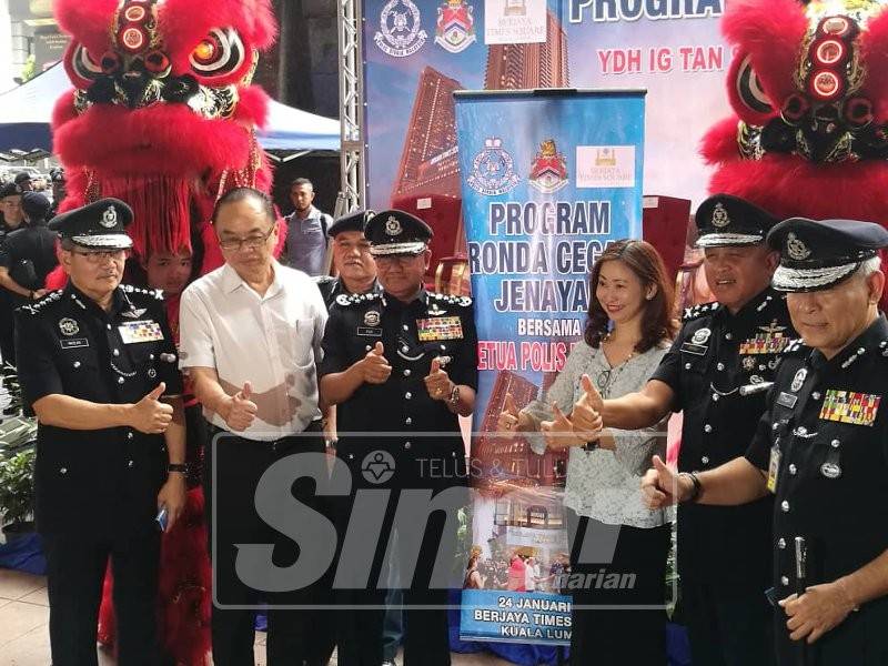 Mohamad Fuzi (tiga, kiri) menunjukkan isyarat bagus ketika merasmikan Program Rondaan Cegah Jenayah di Berjaya Times Square, Kuala Lumpur.