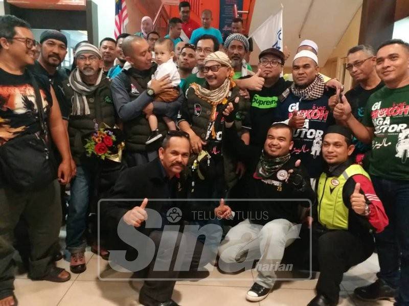 Dua dari kiri, Mohd Zalani, Mohd Fadhli dan Diami disambut meriah oleh rakan-rakan ahli kelab motosikal di ruang legar Lapangan Terbang Sultan Ismail Petra hari ini.