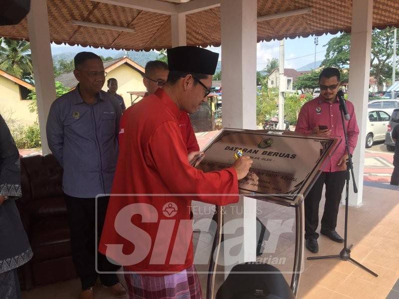 Ahmad Faizal menandatangani plak merasmikan Dataran Beruas, di sini, hari ini.