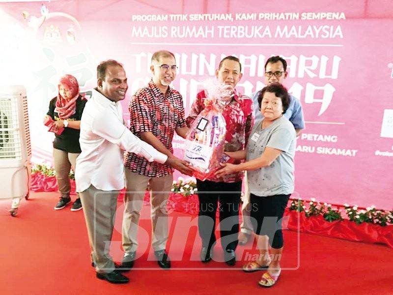 Muhammad Bakhtiar (dua, kiri) dan Aminuddin (tiga, kiri) menyampaikan sumbangan kepada penerima, semalam.