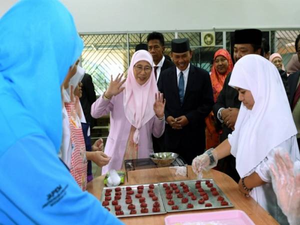 Wan Azizah dibawa melawat kelas kemahiran yang diberikan kepada golongan kurang upaya ketika melakukan lawatan di Pusat Bahagia Brunei hari ini. - Foto Bernama