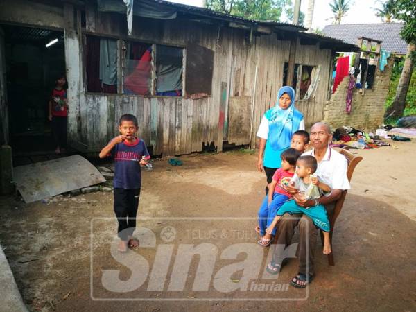 Mansor bersama lima cucunya di hadapan rumah didiami Nor Roslina dan lima anaknya.