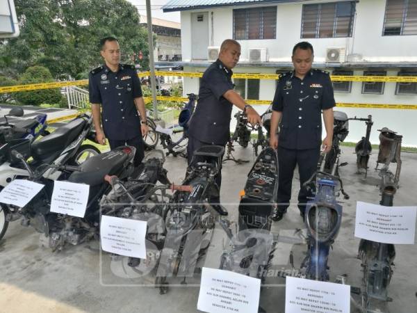 Mohd Zani (tengah) menunjukkan rangka motosikal yang dirampas susulan tertangkapnya dua remaja lelaki.