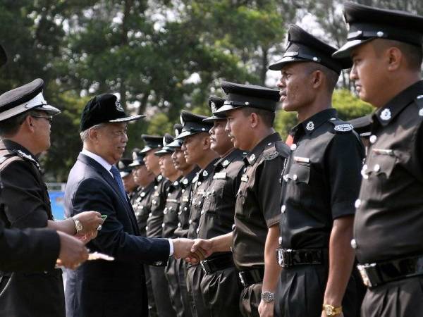 Menteri Dalam Negari Tan Sri Muhyiddin Yassin bersalaman dengan anggota selepas pemakaian pangkat sempena Majlis Sambutan Hari Penjara ke-229 di Maktab Penjara Malaysia hari ini. Foto: Bernama