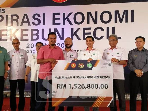 Azmin (tiga, kanan) menyerahkan bantuan Prasarana Asas Pertanian Risda Negeri Kedah kepada wakil Risda Kedah.