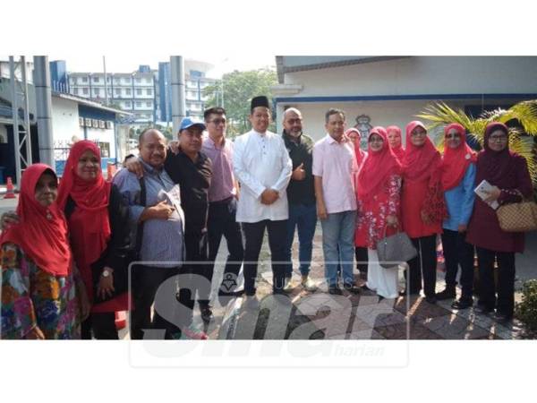 Mohd Razlan (tengah, baju putih) hadir ke Bukit Aman untuk dirakam keterangan berhubung kenyataan kontroversinya.