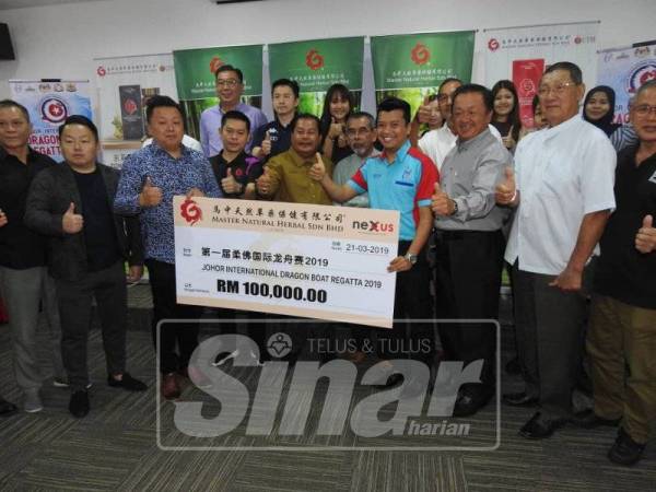 Rosleli (tengah) mewakili Kerajaan Negeri Johor menerima mok cek penajaan berjumlah RM100, 000 pada Majlis Promosi 1st International Dragon Boat Regatta 2019.