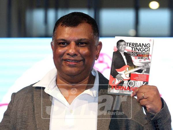 Ketua Pegawai Eksekutif Kumpulan Air Asia, Tan Sri Tony Fernandes bersama bukunya merakamkan gambar sewaktu pelancaran buku berkenaan.- Foto SINAR HARIAN /ASRIL ASWANDI SHUKOR.
