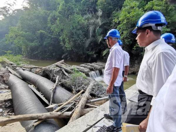 Salehuddin (Kiri) meninjau pembinaan Empangan Sabo di loji rawatan air Sungai Bilut, hari ini.