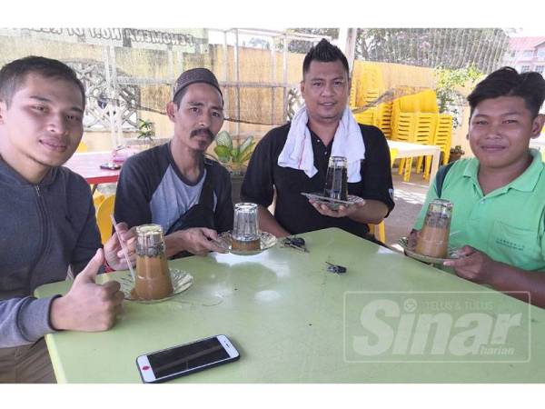 Mohd Fariq (dua, kanan) bersama pelanggannya Aiman Ahmad dan Anuar Ibrahim dari Kubang Kerian yang singgah minum kopi di Cafe Mamaza, Pauh Lima semalam.