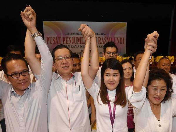 Menteri Kewangan yang juga Setiausaha Agung DAP Lim Guan Eng (dua, kiri) bersama calon DAP Vivian Wong Shir Yee (dua, kanan) mengangkat tangan tanda gembira selepas Suruhanjaya Pilihan Raya mengumumkan kemenangan calon DAP tersebut dengan undi 16,012 dan majoriti 11, 521 di Pusat Penjumlahan Undi di Dewan Aktiviti Sekolah Menengah Jenis Kebangsaan Tiong Hua malam tadi. - Foto Bernama 