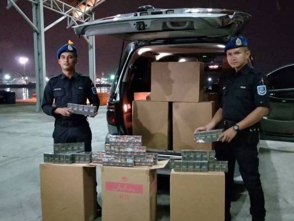 Anggota PPM Pelabuhan Klang menunjukkan rokok seludup pelbagai jenama yang dirampas bersama Toyota Alphard dalam satu operasi di Jalan Banting Klang, Telok Panglima Garang, petang semalam. - FOTO: Ihsan PPM Pelabuhan Klang