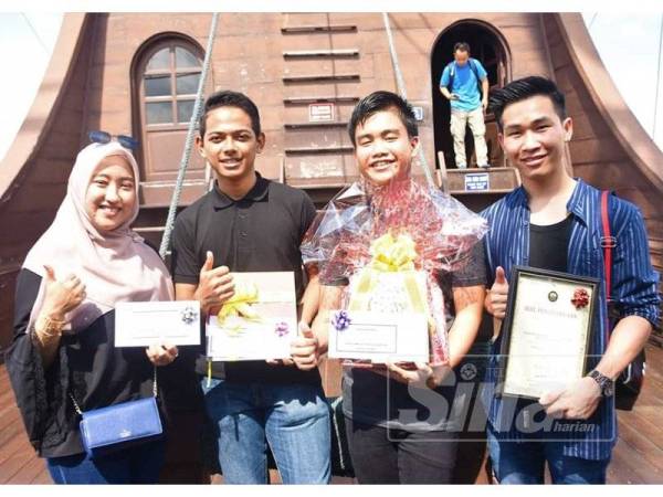 Sitti Fatimathul Zahra (kanan) bersama tiga rakan lain bersama hadiah yang diterima selepas namanya diumumkan sebagai pengunjung bertuah ke 300,000 oleh Perbadanan Muzium Melaka (Perzim) semalam.