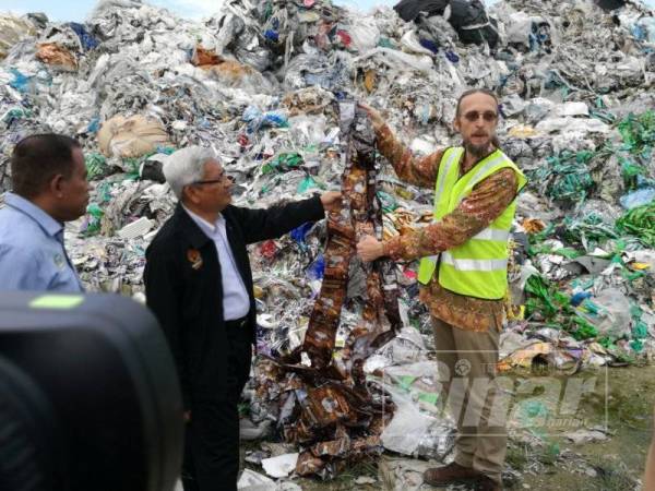 Pavel dan Abdul Aziz menunjukkan sampah plastik di kawasan lambakan sampah plastik