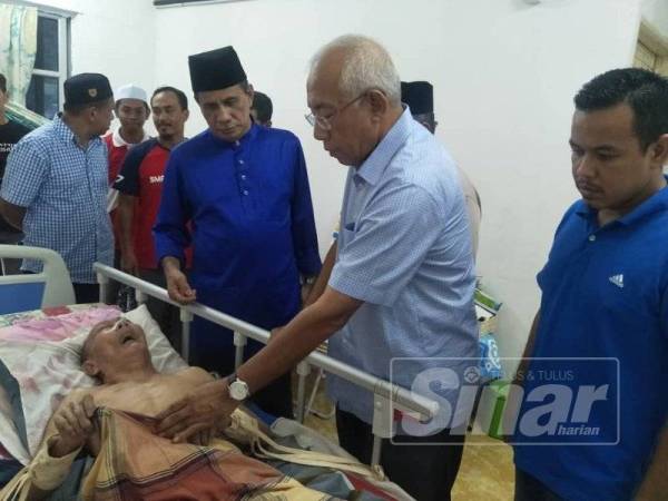 Dari kanan Jasnizam, Mahdzir dan Ghazali bersama konvoi menziarahi Zainol Lebai Mat,78 di Kampung Baru Kuala Nerqng sebelum menyampaikan sumbangan kepada keluarganya.