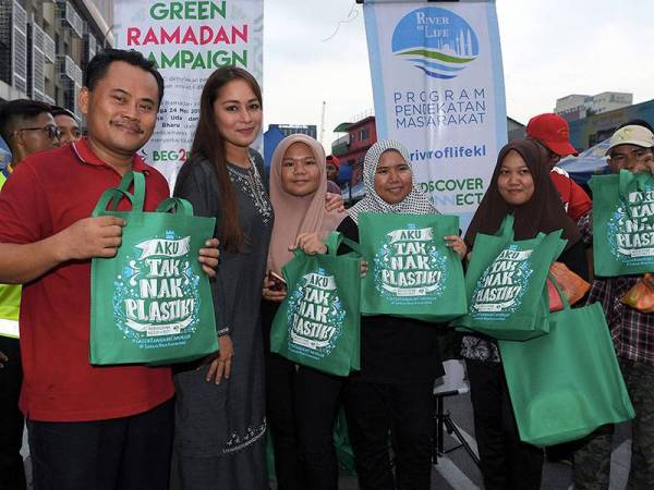 Duta Ikon River of Life (ROL) Maya Karin menyerahkan beg &#039;Aku Tak Nak Plastik&#039; kepada sebahagian penduduk setempat yang hadir di Bazaar Ramadan Jalan Raja Alang Kampung Baru pada Majlis Kempen Ramadhan Hijau hari ini. - Foto Bernama