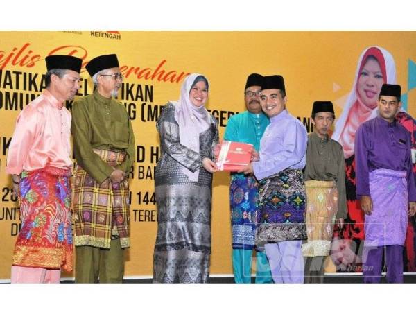 Rina menyampaikan watikah pelantikan MPKK kepada wakil lapan daerah di negeri ini pada majlis penyerahan watikah itu di di Pusat Komuniti Desa (PKD) Terengganu, Bandar Al Muktafi Billah Shah (AMBS) Dungun hari ini.