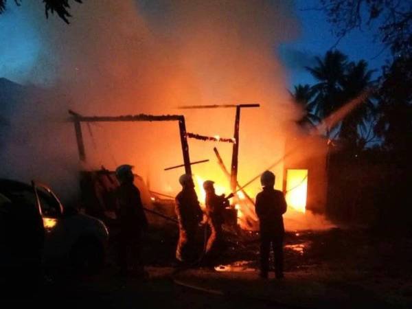 Anggota bomba memadamkan kebakaran rumah di Kampung Pengkalan Nangka, Pengkalan Chepa yang berlaku ketika umat Islam sedang berbuka puasa. - FOTO BOMBA