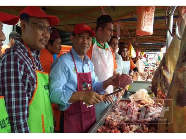 Abdul Yunus memotong daging untuk dijual kepada pengunjung pasar tani dalam jualan happy hour pada Majlis Pelancaran Program Jualan Jimat Belanja Aidilfitri @ Pasar Tani di Pasar Tani Masjid Sultan Nazrin Muizzuddin Shah, di Tapah hari ini.