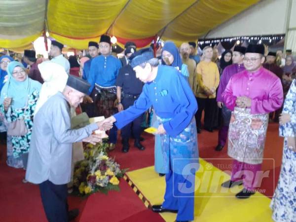 Sultan Selangor berkenan menyampaikan sumbangan duit raya kepada penerima.