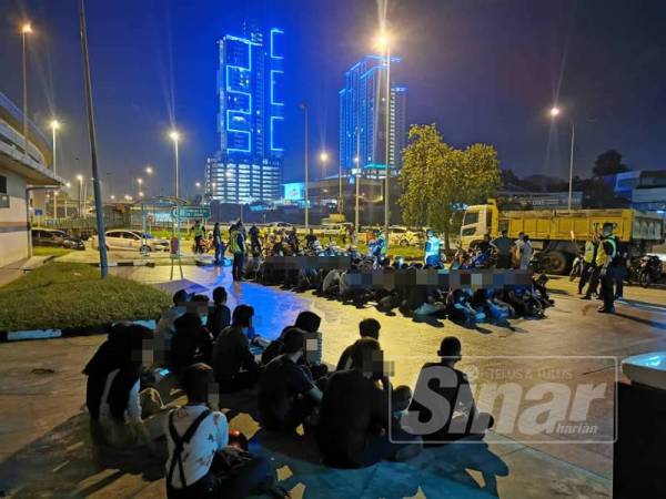 Anggota polis sedang memeriksa penunggang dan pembonceng motosikal dalam Op Samseng Jalanan di Lebuhraya Grand Saga, awal pagi tadi.