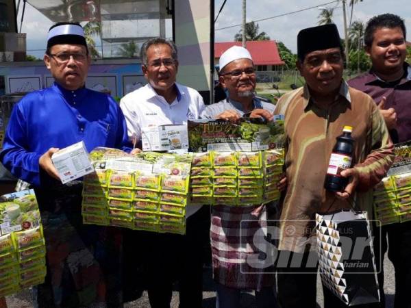 Abdul Fattah (kiri) bersama produk-produk yang dikeluarkan oleh koperasi di Kedah.