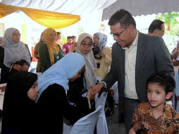 Datuk Seri Saifuddin Nasution bersalaman dengan orang ramai pada Majlis Silaturrahim Aidilfitri Kementerian Perdagangan Dalam Negeri dan Hal Ehwal Pengguna Pulau Pinang hari ini. Foto: Bernama 