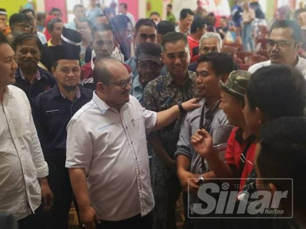 Shamsul Iskandar menyantuni pekebun kecil yang hadir dalam majlis tersebut hari ini.