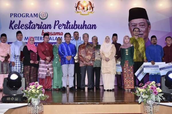 Muhyiddin (tengah) serta Timbalan Ketua Setiausaha (Pengurusan) KDN, Datuk Jamil Rakon (enam, kiri) dan Ketua Pengarah JPPM, Masyati Abang Ibrahim (enam, kanan) bersama para wakil persatuan pada program di Kuala Lumpur. -Foto Bernama