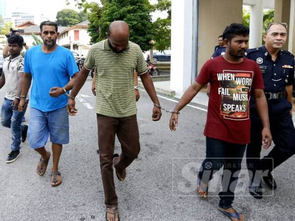 Hla Win (baju biru) dan Gunaselan (baju hijau) mengaku tidak bersalah ke atas tiga pertuduhan memiliki arak haram.