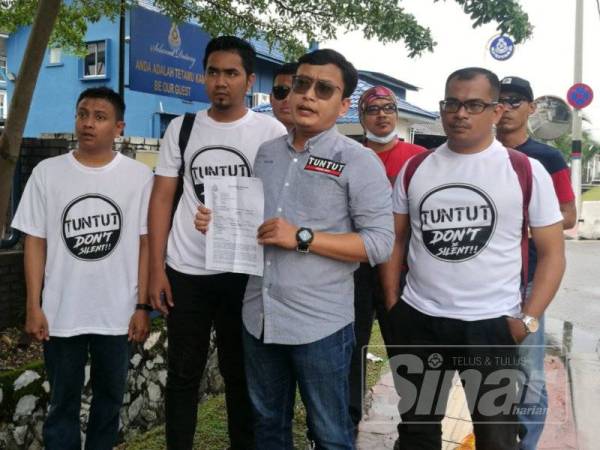 Azlan (tengah) hadir membuat laporan polis di IPD Petaling Jaya.