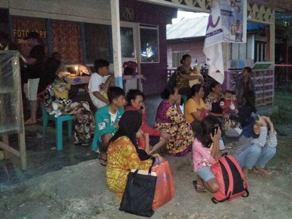 Kebanyakan penduduk duduk di luar rumah masing-masing selepas gempa menggegar Labuha di Maluku Utara kelmarin. - Foto: AFP