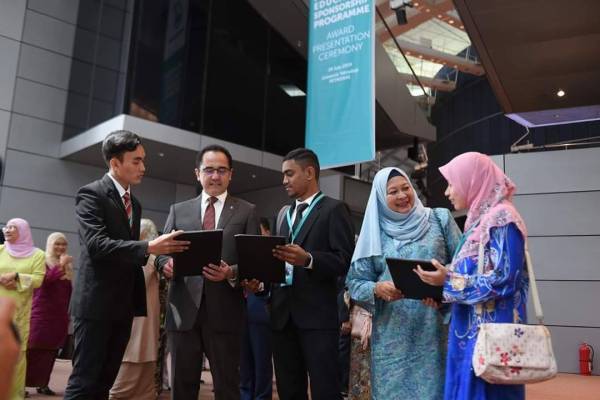 Wan Zulkiflee (dua dari kiri) dan Raiha Azni (dua dari kanan) beramah mesra bersama penerima PESP di UTP hari ini. - Foto ihsan Petronas