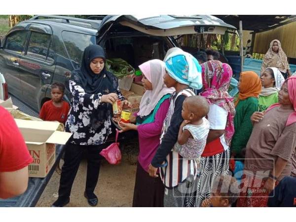 Rasyidah mewakili Zulpuri menyerahkan sumbangan makanan kepada orang asli Kuala Koh dan Aring 5.