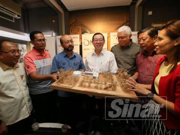 Guan Eng (empat dari kanan) bersama Mukhriz (lima dari kanan) mendengar penerangan tentang pelan projek KDL yang akan dibangunkan di Memorial Tunku Abdul Rahman di sini, hari ini.