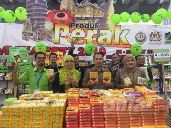 Abdul Yunus (dua dari kanan) menunjukkan pekasam serta produk lain dari Perak yang dijual di Pavilion Perak pada Malaysia Fest 2019 di Bangunan Expo, Changi, Singapura.