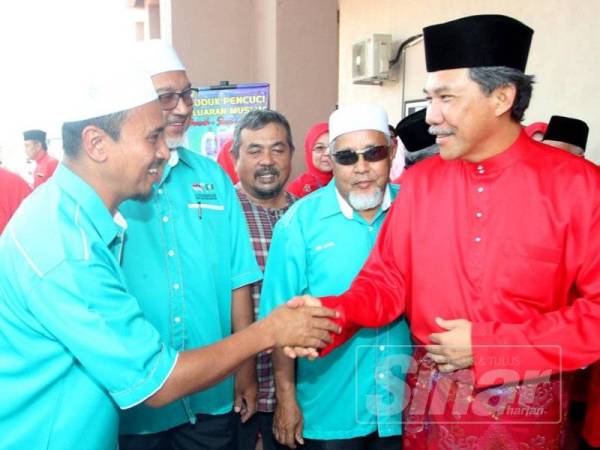 Mohamad (kanan) bersalaman dengan wakil daripada Pas yang turut hadir pada Persidangan UMNO Bahagian Tasek Gelugor petang tadi.