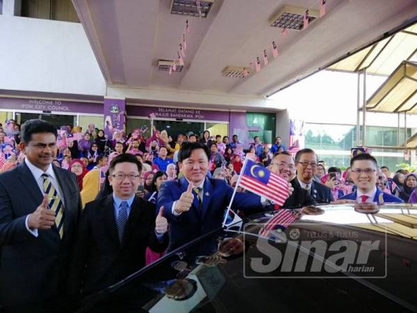 Paul Yong melakukan gimik perasmian program Kibar Jalur Gemilang dengan memasang bendera pada kenderaan rasmi Datuk Bandar Ipoh di sini hari ini.